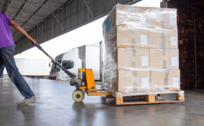 Warehouse,Logistics,And,Transportation,,Worker,With,Hand,Pallet,Truck,Unloading